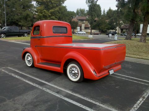 2004 Ford Crown Victoria - This custom pickup truck features a bright red paint job and classic styling.
