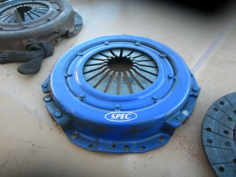 1984 Ford Bronco - A blue SPEC clutch pressure plate is shown next to a clutch disc, with another pressure plate in the background.