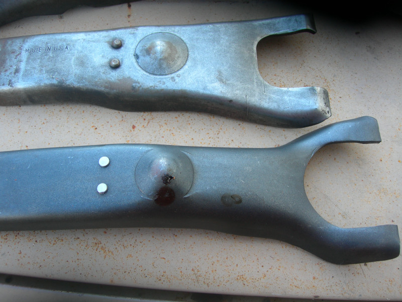 Two metal clutch forks, one says MADE IN USA
