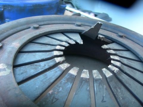 1984 Ford Bronco - Close-up of a damaged clutch pressure plate, showing a broken diaphragm spring tab.
