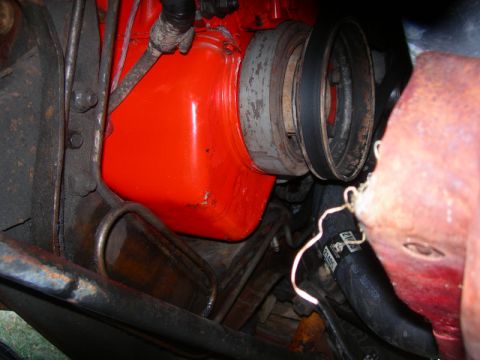 1984 Ford Bronco - A view of the engine bay shows a belt and pulley system attached to the engine block.