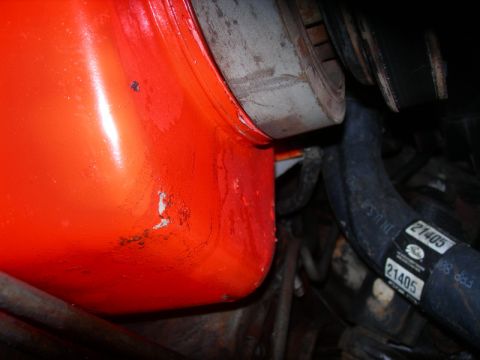 1984 Ford Bronco - Close-up view of an engine component, likely an oil pan, with associated mechanical parts.
