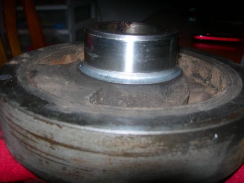1984 Ford Bronco - This is a close-up view of a crankshaft pulley, showing a bearing installed in the center bore.