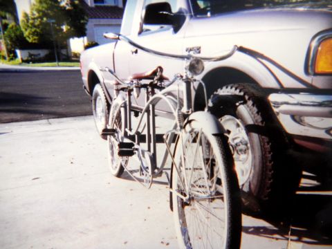 1997 Ford Ranger - A vintage bicycle is parked alongside a 1997 Ford Ranger pickup truck.
