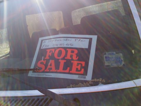 1990 Ford Bronco - A "FOR SALE" sign on the windshield of a Ford Bronco indicates it has a 1986 engine and is priced at $700.