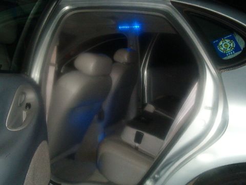 1998 Ford Taurus - Car interior with blue ambient lighting visible on the ceiling and under the seats.