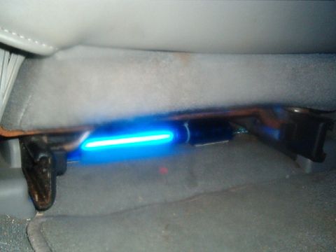 1998 Ford Taurus - A blue LED light strip is installed beneath the passenger seat of a vehicle.