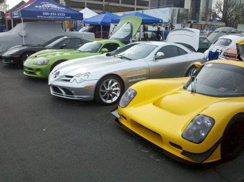 2004 Ford Crown Victoria - A collection of sports cars are displayed at an outdoor event.