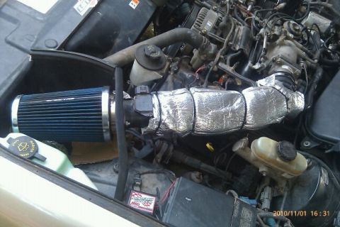 2000 Mercury Grand Marquis - Aftermarket air intake system installed in a vehicle's engine bay.