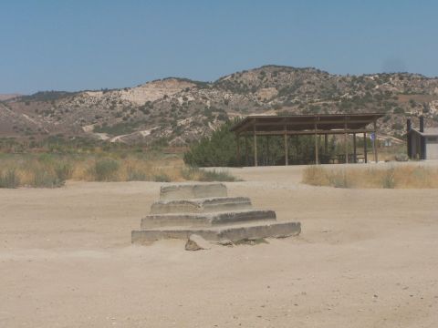 1990 Ford Bronco - Outdoor scene with concrete steps in the foreground and a picnic shelter in the distance under a clear blue sky.