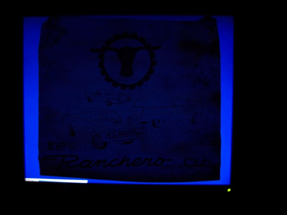 Backlit vintage Ranchero Club banner with steer emblem and car-pickup drawings