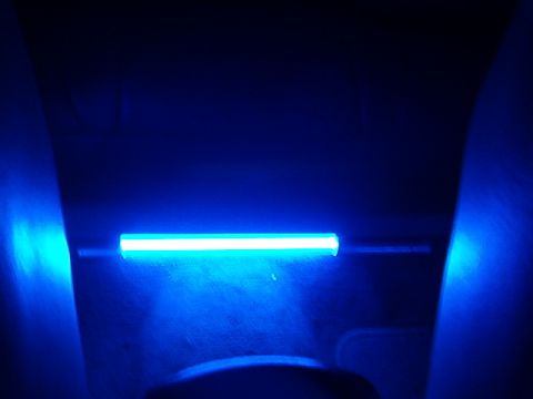 1998 Ford Taurus - A blue light bar illuminates the dashboard of a car, casting a blue glow on the interior panels.