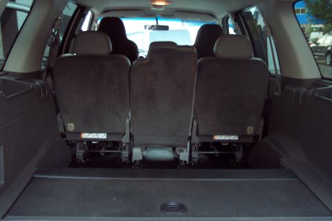 2001 Ford Crown Victoria - The interior of an SUV shows the back of the rear seats folded down.
