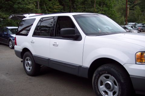 2001 Ford Crown Victoria - A white 2003 Ford Expedition is parked outdoors with its rear hatch open.