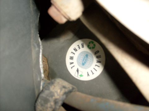 1994 Ford Bronco - A circular sticker indicating Ford quality renewal is visible on a dark surface.