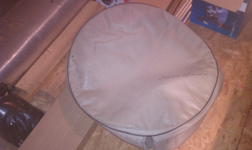 Tan spare tire cover with embroidered text