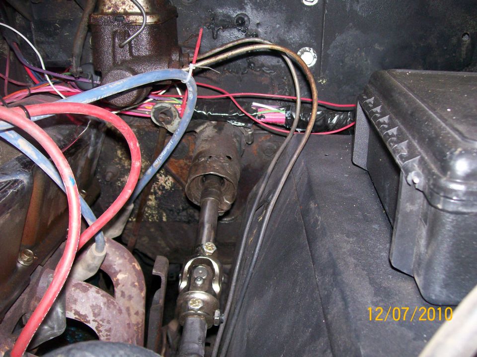 Steering shaft and U-joint at firewall with wiring and headers in an engine bay, dated 12/07/2010