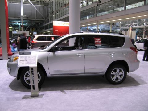 1991 Ford LTD Crown Victoria - Silver SUV on display at an auto show, with another vehicle visible in the background.