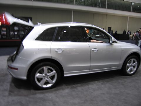 1991 Ford LTD Crown Victoria - A silver Audi Q5 SUV is shown from the side in an indoor setting, possibly a car show.
