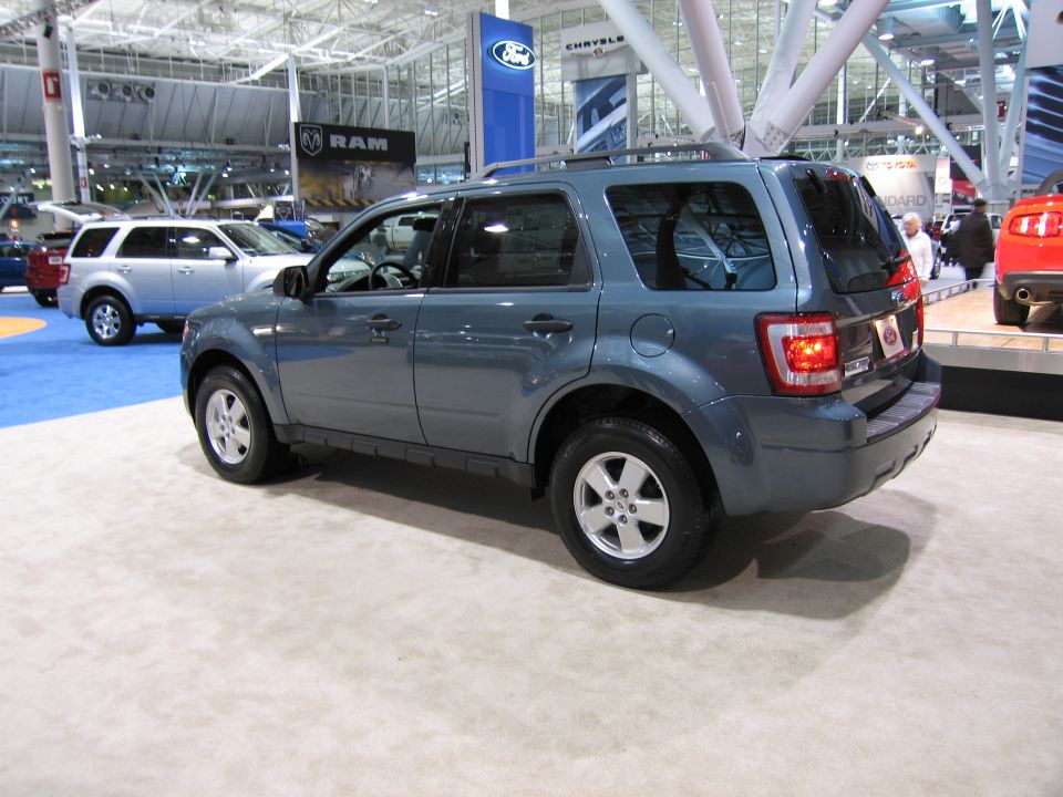 Blue SUV parked indoors with other vehicles visible