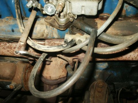 1966 Ford Bronco - Engine bay detail showing vacuum lines and carburetor assembly.