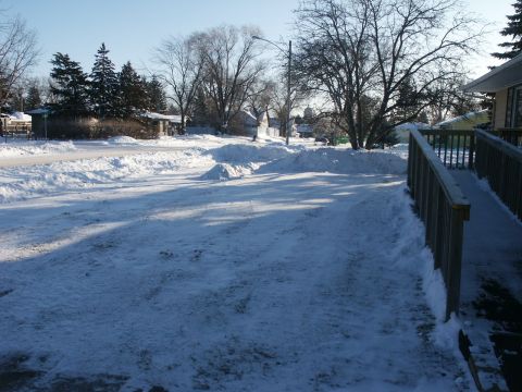 1966 Ford Bronco - A winter scene shows a snow-covered driveway leading up to a residential house.