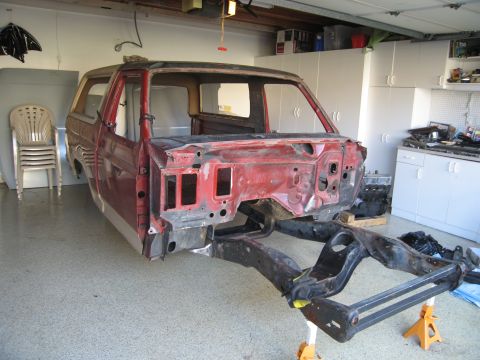 1986 Ford Bronco - This Ford Bronco body is undergoing restoration, with the chassis separated and supported by stands.