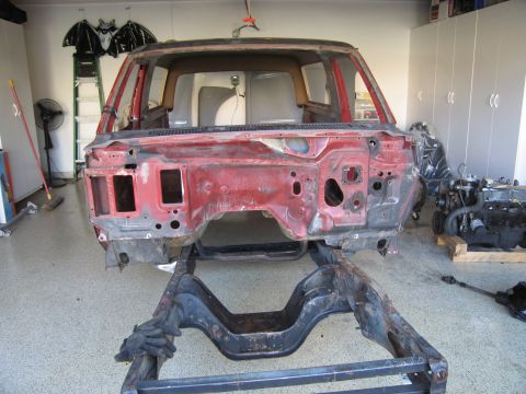 1986 Ford Bronco - The body of a 1986 Ford Bronco is shown stripped down to its frame, undergoing restoration.