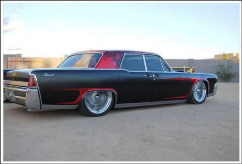 1991 Ford LTD Crown Victoria - This custom Lincoln Continental features a two-tone paint scheme with red accents and chrome wire wheels.