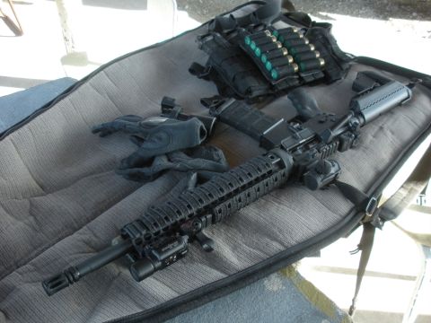 1996 Ford Bronco - Tactical rifle setup with ammunition and gloves displayed on a gun case.