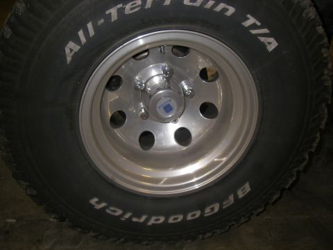 1990 Ford Bronco - Alcoa wheel and BFGoodrich All-Terrain T/A tire detail. The center cap shows the Alcoa logo.