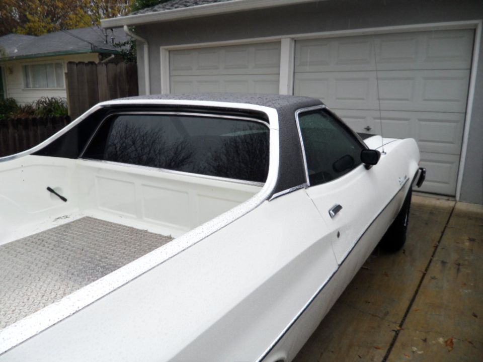 White 1973 Ford Ranchero, 3/4 front view, black vinyl roof