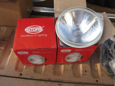 1986 Ford Bronco - Boxes of Autopal headlight units are shown, with one lamp visible outside its packaging.