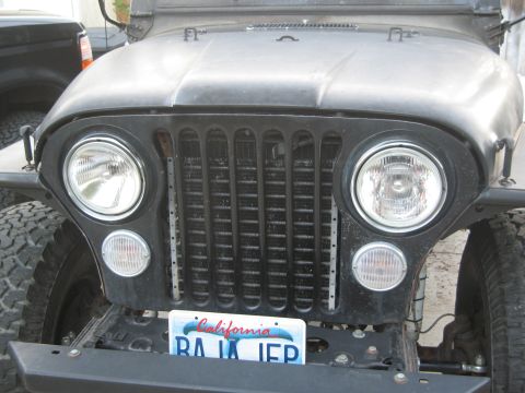 1986 Ford Bronco - This Jeep CJ-series features a distinctive grille and front-end design, with a California license plate visible.