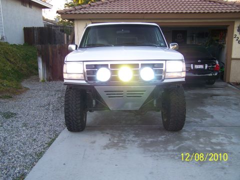 1995 Ford Bronco - This 1995 Ford Bronco is modified with a custom bumper and auxiliary lights, parked in a driveway.