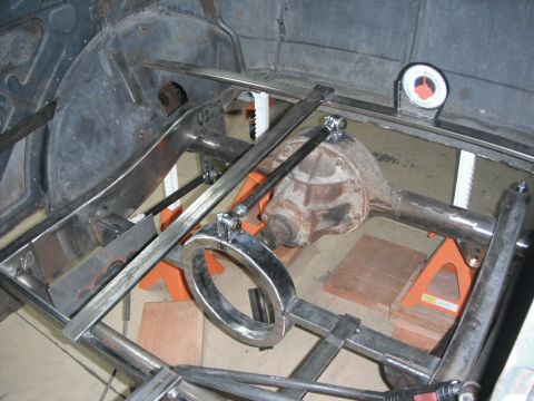 1986 Ford Bronco - Custom fabrication work on a vehicle's rear axle and frame, showing suspension and structural additions.