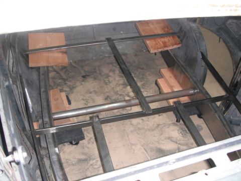 1986 Ford Bronco - The interior of a vehicle shows custom metal framing and wooden blocks, suggesting a modification or repair project.