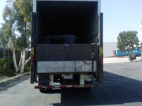 1986 Ford Bronco - A vehicle body is being transported inside a large truck.