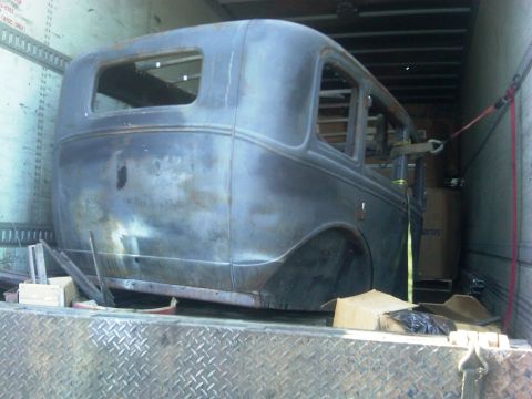 1986 Ford Bronco - A 1931 Ford Model A sedan body is seen being transported inside a trailer.