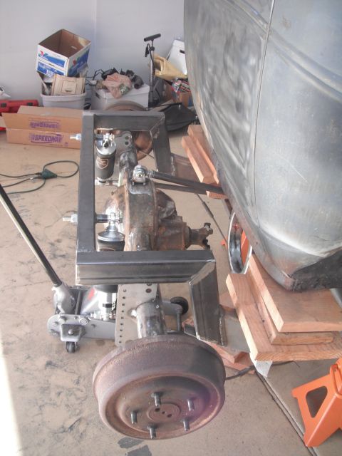 1986 Ford Bronco - Close-up view of a vehicle's rear axle and suspension system during repair or modification.