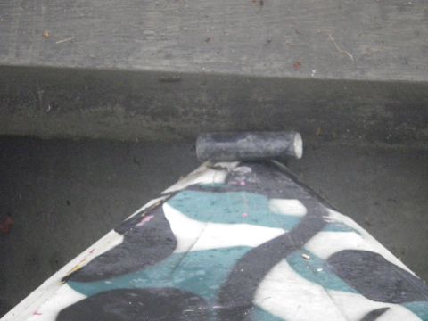 1991 Ford Bronco - A close-up view of a camouflage painted object with a pipe attached to its top surface.