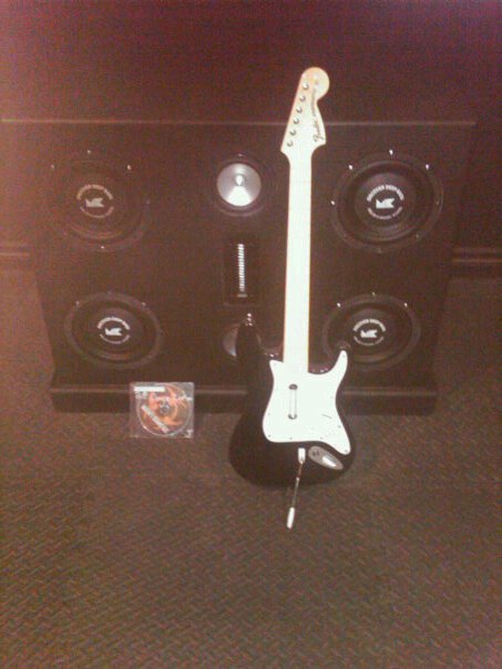 1987 Ford Bronco - A black electric guitar and a large speaker cabinet are displayed together, with a CD case on the floor.