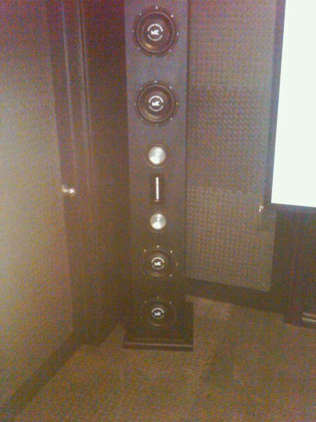 1987 Ford Bronco - A tall speaker cabinet is positioned in a room with a projector screen visible.