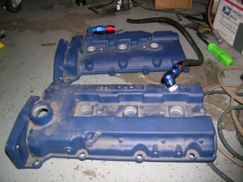 1995 Ford Probe - Two blue engine valve covers, one with "MAZDA" text, are shown on a workshop floor.
