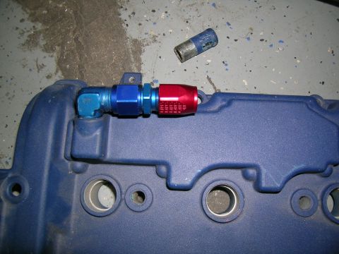 1995 Ford Probe - Close-up of a blue engine component with AN fittings, possibly for a turbo build.