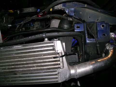1995 Ford Probe - Custom engine bay modifications an intercooler and custom piping, with visible text on a hose.