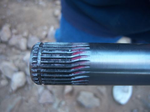 Suzuki Samurai - A close-up view of a metal shaft with visible splines and red markings.