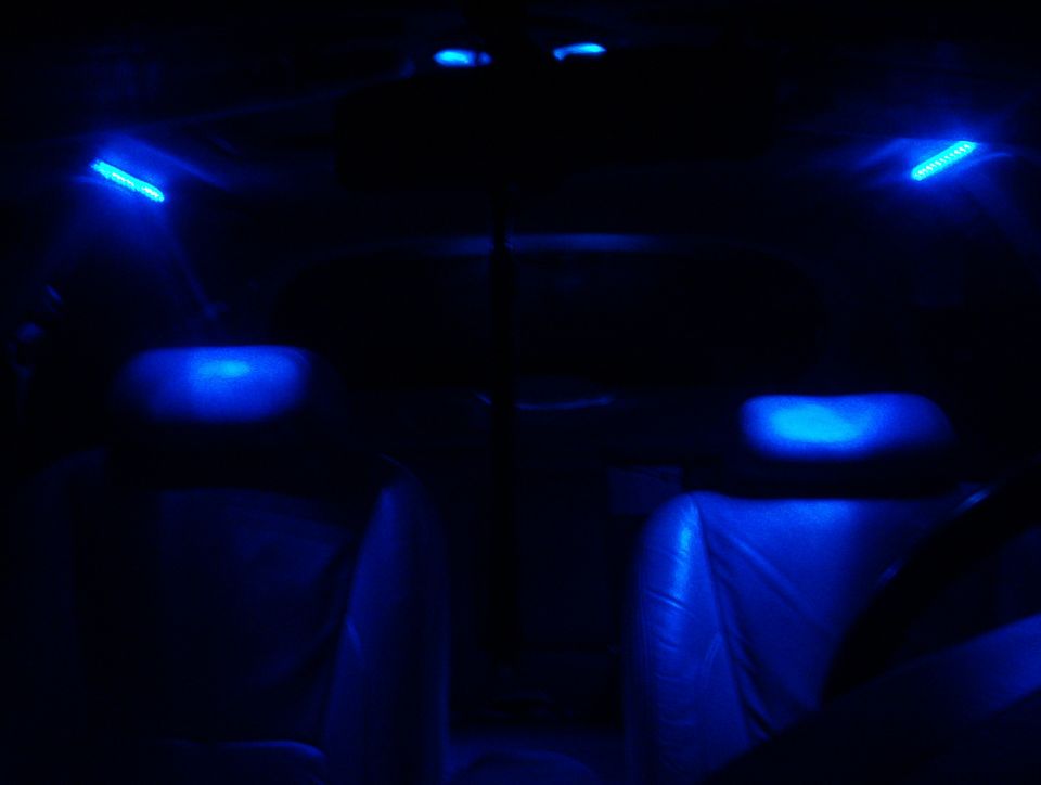 Interior with blue ambient lighting, seats visible