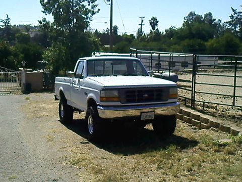 1995 Ford F-150 - This 1995 Ford F-150 pickup truck is seen from a front 3/4 angle, parked outdoors.