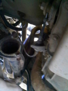1995 Ford F-150 - Close-up view of vehicle exhaust components, with a SuperMotors.net logo at the bottom.